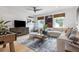 Stylish living room with a comfortable sectional sofa, natural light, and a foosball table for entertainment at 208 Quimby Hill Dr, Huger, SC 29450
