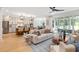 Open-concept living space with modern kitchen, living room with fireplace, and backyard access at 208 Quimby Hill Dr, Huger, SC 29450