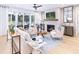 A well-lit living room featuring a fireplace, plush seating, stylish decor, and access to the backyard at 208 Quimby Hill Dr, Huger, SC 29450