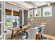 Stylish home office featuring a wooden desk, gray paneled walls, exposed beam ceiling and an abundance of natural light at 208 Quimby Hill Dr, Huger, SC 29450
