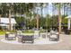 Charming outdoor seating area with modern chairs surrounding a fire pit, perfect for entertaining guests and relaxing evenings at 208 Quimby Hill Dr, Huger, SC 29450