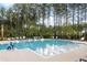 Sparkling swimming pool featuring in-pool loungers and accessibility lift for a relaxing and inclusive experience at 208 Quimby Hill Dr, Huger, SC 29450