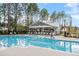 Expansive swimming pool with a covered pavilion, offering a perfect blend of recreation and relaxation in a scenic setting at 208 Quimby Hill Dr, Huger, SC 29450