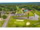 Community aerial view of a golf course, swimming pool, clubhouse, and pond at 23 Hunters Forest Dr, Charleston, SC 29414