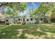 Charming backyard featuring a patio seating area and a spacious lawn surrounded by mature trees at 23 Hunters Forest Dr, Charleston, SC 29414