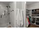 Bathroom featuring glass shower with tiled walls adjacent to open closet at 23 Hunters Forest Dr, Charleston, SC 29414
