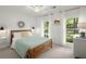 Cozy bedroom with natural light, white walls, wood bed frame and overhead fan at 23 Hunters Forest Dr, Charleston, SC 29414