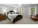 Bright bedroom featuring a black bed frame, neutral walls, and natural light from the window at 23 Hunters Forest Dr, Charleston, SC 29414