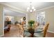 Elegant dining area with a glass table set for four, connected to the living room and kitchen at 23 Hunters Forest Dr, Charleston, SC 29414