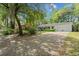 Traditional home with a long driveway and attached two-car garage, surrounded by mature trees at 23 Hunters Forest Dr, Charleston, SC 29414