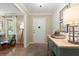 Warm and inviting foyer with console table, stylish decor, wood floors and view of the front door at 23 Hunters Forest Dr, Charleston, SC 29414