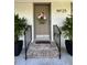 Charming front door entrance with brick steps, black railing, and decorative flower basket with address number above at 23 Hunters Forest Dr, Charleston, SC 29414
