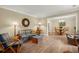 Spacious living room featuring wood-look floors and stylish seating area, seamlessly connecting to the dining room at 23 Hunters Forest Dr, Charleston, SC 29414