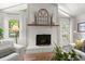Bright living room features a fireplace, hardwood floors, and abundant natural light at 23 Hunters Forest Dr, Charleston, SC 29414