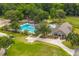 Aerial view of a community pool with a large swimming area, lounge chairs, and a clubhouse at 23 Hunters Forest Dr, Charleston, SC 29414