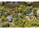 An aerial view of a stunning home surrounded by lush greenery, a pond, and mature trees at 2455 The Bent Twig, Seabrook Island, SC 29455