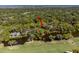 An aerial view showcases the home's location near a river, golf course, and lush, mature trees at 2455 The Bent Twig, Seabrook Island, SC 29455