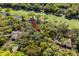 A high-angle view shows a beautiful home surrounded by a lake, a golf course, and mature trees at 2455 The Bent Twig, Seabrook Island, SC 29455