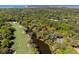 Aerial view displays the home near a river and a golf course, set among mature trees at 2455 The Bent Twig, Seabrook Island, SC 29455