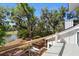 Elevated balcony overlooking a wooded area, features modern railings and outdoor seating at 2455 The Bent Twig, Seabrook Island, SC 29455