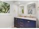 Bright bathroom featuring a navy blue vanity with double sinks, marble countertop and decorative gold fixtures at 2455 The Bent Twig, Seabrook Island, SC 29455