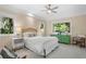 Bright bedroom with neutral walls, white bedding, ceiling fan, and view of nature at 2455 The Bent Twig, Seabrook Island, SC 29455