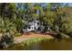 Beautiful exterior view of waterfront home surrounded by lush greenery and trees with Spanish moss at 2455 The Bent Twig, Seabrook Island, SC 29455