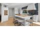 Modern kitchen featuring a large island with seating, white cabinets, and stylish backsplash at 2455 The Bent Twig, Seabrook Island, SC 29455