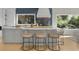 A kitchen island with seating and views of the outdoors, perfect for casual dining and entertaining guests at 2455 The Bent Twig, Seabrook Island, SC 29455