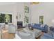 Bright living room with fireplace, ample seating, and large windows offering scenic views at 2455 The Bent Twig, Seabrook Island, SC 29455