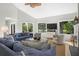 Spacious living room with vaulted ceiling, large windows, comfortable seating, and TV viewing area at 2455 The Bent Twig, Seabrook Island, SC 29455