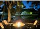 Inviting outdoor space with fire pit, seating, and tranquil water view at dusk at 2455 The Bent Twig, Seabrook Island, SC 29455