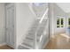 Bright interior staircase with white railings and hardwood flooring at 2455 The Bent Twig, Seabrook Island, SC 29455