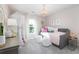 This bedroom features a daybed, decorative chandelier, and neutral tones, creating a soft and inviting space at 263 Camellia Bloom Dr, Moncks Corner, SC 29461