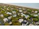 Breathtaking aerial view of a coastal neighborhood with lush trees, close proximity to the beach, and stunning architecture at 3007 Cameron Blvd, Isle of Palms, SC 29451