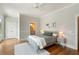 Bright bedroom with wood floors, ceiling fan, and ensuite bathroom at 3007 Cameron Blvd, Isle of Palms, SC 29451