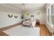 Bright bedroom featuring light walls, wood floors, a ceiling fan and two windows overlooking the yard at 3007 Cameron Blvd, Isle of Palms, SC 29451