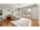 Bright bedroom featuring light walls, wood floors, a ceiling fan and large windows overlooking the yard at 3007 Cameron Blvd, Isle of Palms, SC 29451