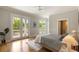 Bright bedroom featuring French doors to the balcony, light walls, wood floors, and a ceiling fan at 3007 Cameron Blvd, Isle of Palms, SC 29451