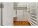 Walk-in closet featuring custom shelving, drawers, hanging rods and natural light from a transom window at 3007 Cameron Blvd, Isle of Palms, SC 29451