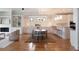 Open-concept dining room boasts hardwood floors, statement lighting, and access to kitchen at 3007 Cameron Blvd, Isle of Palms, SC 29451