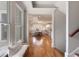 Inviting entryway leads to an open-concept kitchen and dining area, enhanced by natural light and wood floors at 3007 Cameron Blvd, Isle of Palms, SC 29451