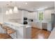 Bright kitchen with stainless steel appliances, hardwood floors, and a bar with seating at 3007 Cameron Blvd, Isle of Palms, SC 29451