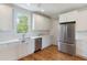 Bright kitchen with stainless steel appliances, hardwood floors, and a beautiful window at 3007 Cameron Blvd, Isle of Palms, SC 29451
