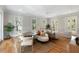 Open-concept living room featuring hardwood floors, natural light, stylish seating, and a comfortable dining area at 3007 Cameron Blvd, Isle of Palms, SC 29451