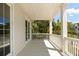 Covered porch with white railings and a view of lush greenery at 3007 Cameron Blvd, Isle of Palms, SC 29451