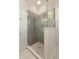 Modern shower featuring gray subway tile, a glass enclosure and a white honeycomb floor tile design at 3007 Cameron Blvd, Isle of Palms, SC 29451