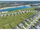 Aerial shot of a community, highlighting the pool, serene lakes, and manicured lawns at 308 Cypress Branch Rd, Huger, SC 29450