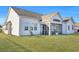 A bright, white house with a well-kept lawn and screened-in porch perfect for enjoying the outdoors at 308 Cypress Branch Rd, Huger, SC 29450