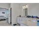 Bright bathroom showcasing double sinks, white cabinets and countertops, and modern lighting at 308 Cypress Branch Rd, Huger, SC 29450